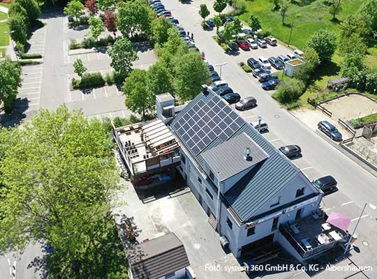 Saniertes Hotel Restaurant aus der Vogelperspektive mit vielen Parkplätzen.